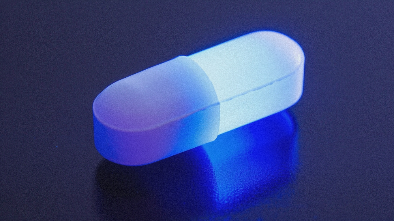 Glowing blue pharmaceutical capsule with gradient lighting representing BioCryst pediatric Orladeyo PDUFA decision for first oral hereditary angioedema prophylaxis in children under 12, as XBI rallies 1.8% on cool CPI removing macro overhang and double regulatory catalyst Friday creates binary volatility opportunities